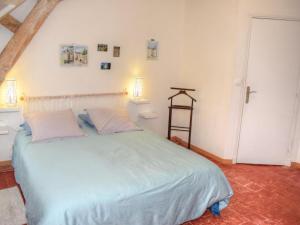 a bedroom with a large bed with two pillows at Gîte Chemillé-sur-Indrois, 3 pièces, 4 personnes - FR-1-381-444 in Chemillé-sur-Indrois