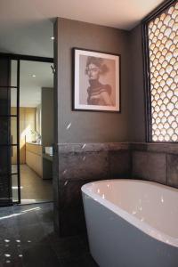 a bathroom with a tub and a picture on the wall at Design Penthouse private panoramic terrace in La Concepción