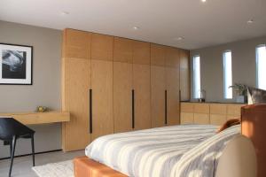 a bedroom with a large bed with wooden cabinets at Design Penthouse private panoramic terrace in La Concepción