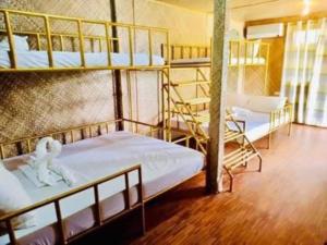 a room with three bunk beds in a dorm at White Chocolate Hills Resort in Zamboanguita