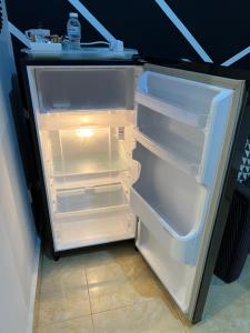 an empty refrigerator with its door open in a room at HIPSTER STUDIO at Kuala Berang for 2Pax -Free Netflix & Wifi in Kuala Berang