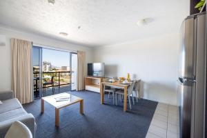 - un salon avec un canapé et une table dans l'établissement Aligned Corporate Residences Townsville, à Townsville