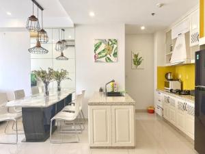 a kitchen with white cabinets and a white counter top at River gate Yourhomes 2br in Ho Chi Minh City
