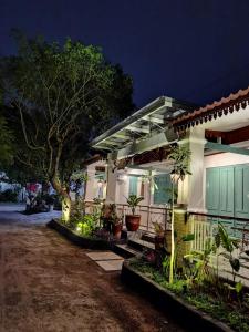 a house with a porch at night at Ndalem Kinasih Homestay Syariah in Solo