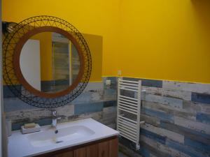 a bathroom with a sink and a mirror at Maison Bangor, 3 pièces, 4 personnes - FR-1-418-215 in Bangor