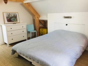 a bedroom with a bed and a dresser and a chair at Appartement Le Palais, 2 pièces, 4 personnes - FR-1-418-219 in Le Palais