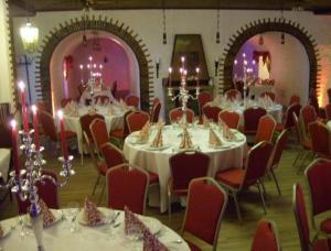 a room filled with tables and chairs with white tablecloths at Gutshof Ziegelhütte in Edenkoben