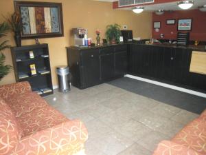 a waiting room with two couches and a counter at Motel 8 Maricopa in Maricopa