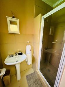a bathroom with a sink and a shower at Lighthouse Inn in Bloemfontein +18 photos