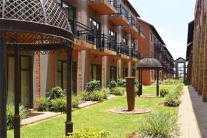a row of buildings with plants in front of them at Lighthouse Inn in Bloemfontein