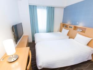Postel nebo postele na pokoji v ubytování Shibuya Tobu Hotel