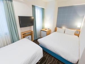Postel nebo postele na pokoji v ubytování Shibuya Tobu Hotel