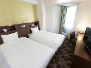 Postel nebo postele na pokoji v ubytování Shibuya Tobu Hotel
