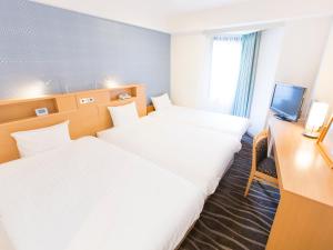 Postel nebo postele na pokoji v ubytování Shibuya Tobu Hotel