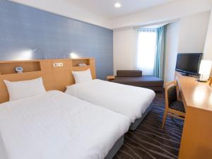 Postel nebo postele na pokoji v ubytování Shibuya Tobu Hotel