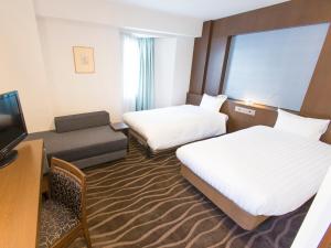 Postel nebo postele na pokoji v ubytování Shibuya Tobu Hotel