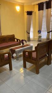 a living room with two chairs and a table at D'Rhu Homestay with 2 aircond in Bachok