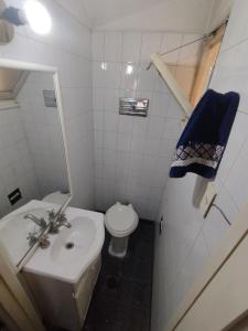 a small bathroom with a toilet and a sink at Casa de papel in Mendoza