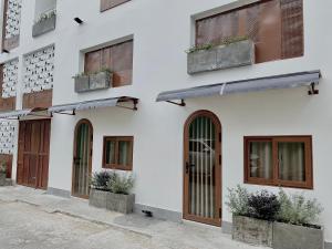 a facade of a building with doors and windows at Mưa home in Da Nang