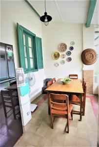 a dining room with a wooden table and chairs at Ndalem Kinasih Homestay Syariah in Solo