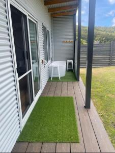 a porch with a table and green grass at Acacia Hills Retreat in Acacia Hills
