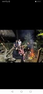een groep mensen die rond een vuur zitten bij Sagada Heritage Village in Sagada