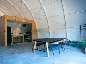 a ping pong table in the middle of a room at FOX&CRANE Cabin -TSURUI Sauna&Cabins- 
