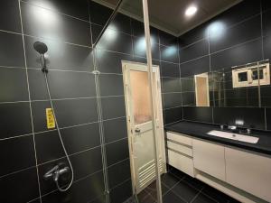 a bathroom with a shower and a sink at Fun Hotspring in Jiaoxi +9 photos