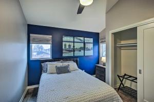a bedroom with blue walls and a bed at Green Bay Getaway Near Lambeau Field and Resch! in Green Bay