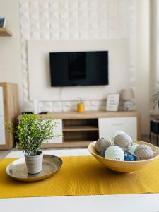 a living room with a table with a bowl of eggs at Sweet Central Apartment ,in the City center in Eger