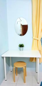 a white table with a mirror and a stool at EA Homestay Lembah Bujang Merbok in Bedung