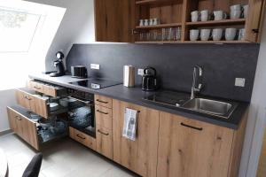 a kitchen with a sink and a stove top oven at Casa de Alpaca in Schmelz