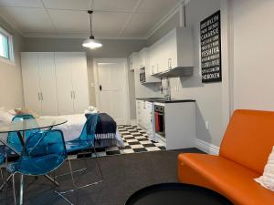 a room with a bed and a table and chairs at Beach Front Studio Napier in Napier
