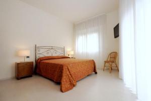 Postel nebo postele na pokoji v ubytování Hotel Sorriso