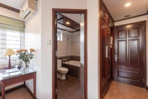 a bathroom with a toilet and a sink at T - Apartment in Hanoi