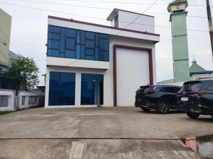a house with a car parked in front of it at Hiast Syariah Residence in Palembang
