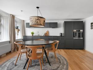 a kitchen with a dining room table and chairs at Regent 4- Cute 1-Bdr Apt in Centre of Copenhagen in Copenhagen