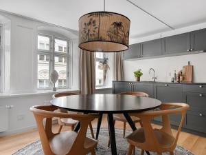 a kitchen with a dining room table and chairs at Regent 4- Cute 1-Bdr Apt in Centre of Copenhagen in Copenhagen