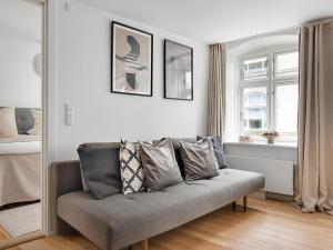 a living room with a couch and a window at Regent 4- Cute 1-Bdr Apt in Centre of Copenhagen in Copenhagen +17 photos