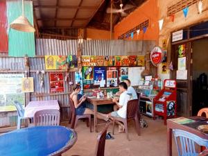 a group of people sitting at a table in a restaurant at Reggae bar homestay& Sona trekking tour in Banlung +82 photos