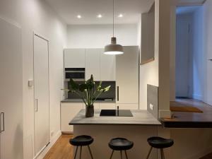 a kitchen with a island with stools and a counter top at LOFT sull'acqua con vista mozzafiato in Naples