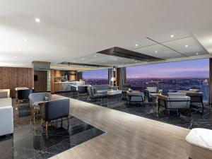 a restaurant with a view of a city at Royal Malioboro by ASTON in Yogyakarta