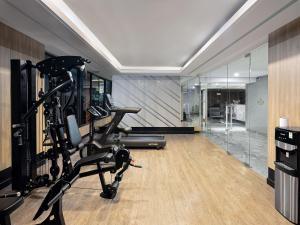 a gym with a elliptical machine in a room at Royal Malioboro by ASTON in Yogyakarta