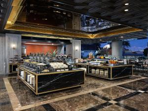 a buffet line with food on display in a restaurant at Royal Malioboro by ASTON in Yogyakarta