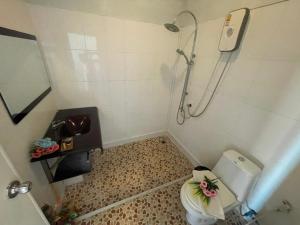 a small bathroom with a shower and a toilet at KK Lipe Resort in Ko Lipe