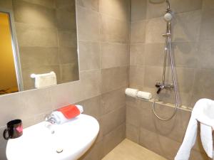 a bathroom with a sink and a shower at Auberge des Avenières in Les Avenières