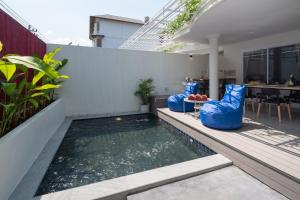 a swimming pool in the backyard of a house at Chala At Nimman in Chiang Mai