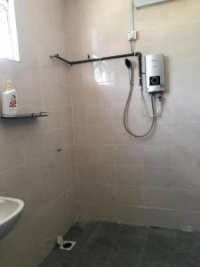 a bathroom with a shower and a sink at HJ Homestay in Kuala Terengganu