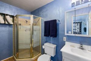 a bathroom with a shower and a toilet and a sink at High View Haven - Hot Tub, Fire Pit & BBQ in Joshua Tree! home in Joshua Tree