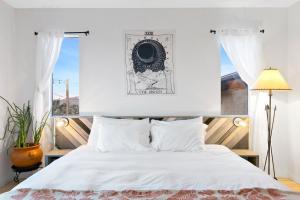 a bedroom with a white bed and a window at High View Haven - Hot Tub, Fire Pit & BBQ in Joshua Tree! home in Joshua Tree